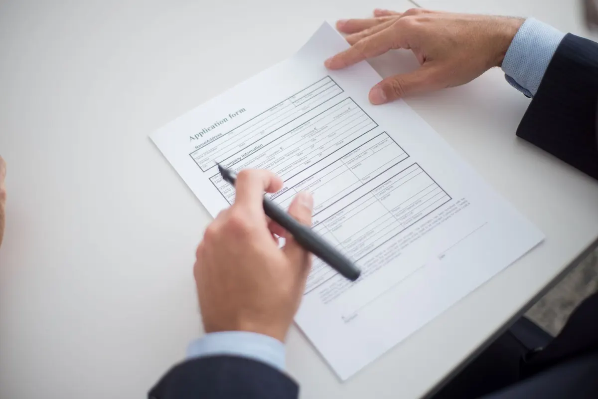 Hiring manager reviewing a job applicant's background check authorization form